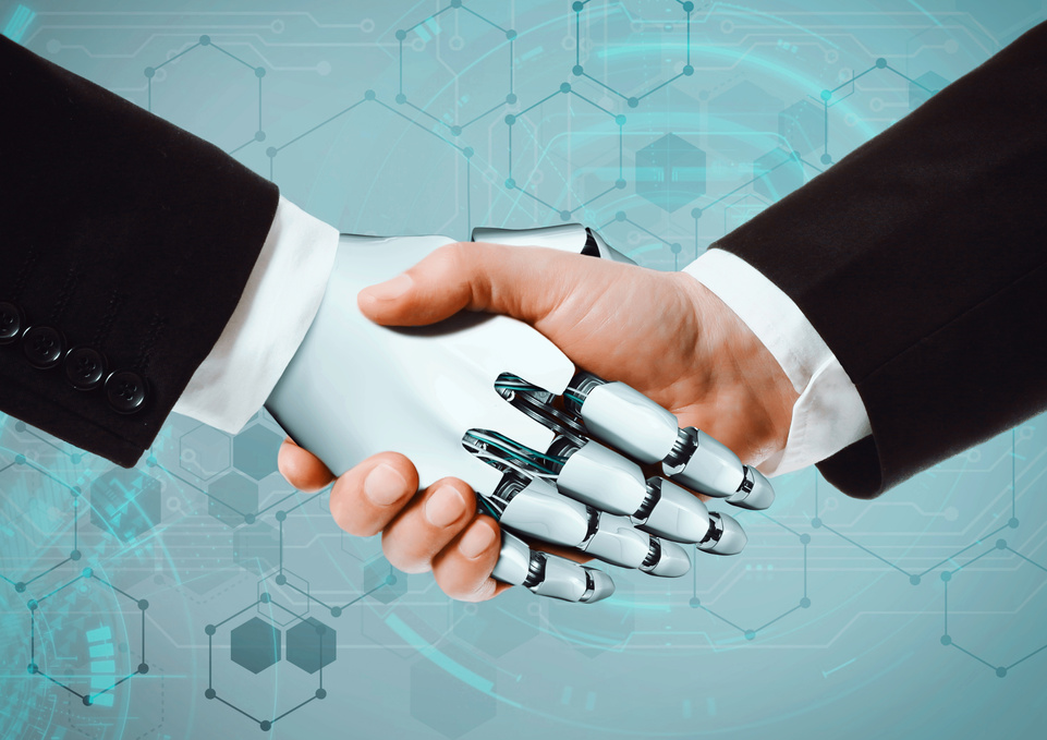 human hands and robot hand shaking hands